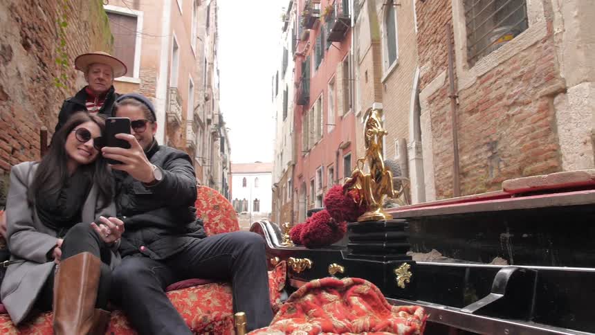 People take selfies while riding on a gondola