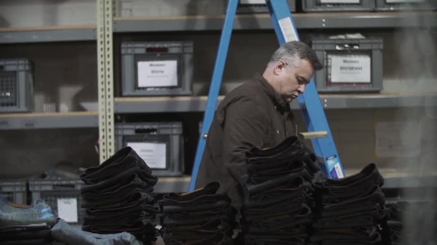 Man stacking items on a table