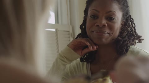 A woman talks to another woman