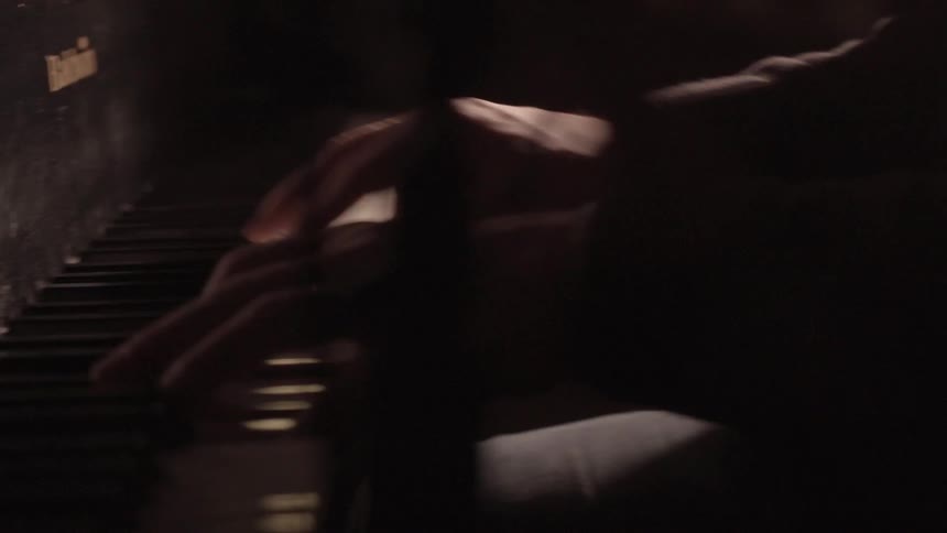 Man plays the piano indoors