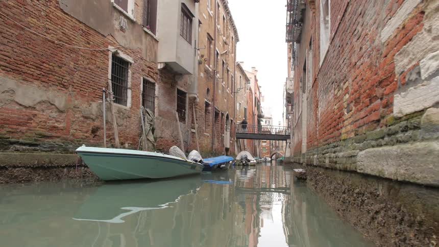 Boats docked in a canal in a city