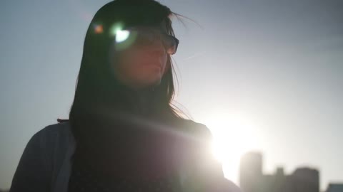 Woman with sunglasses standing outside