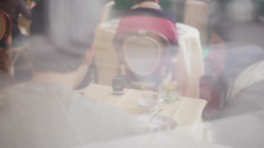 A group of people sitting inside of a restaurant