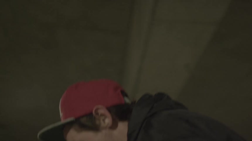 Man rides a skateboard by pushing one foot on the ground at night