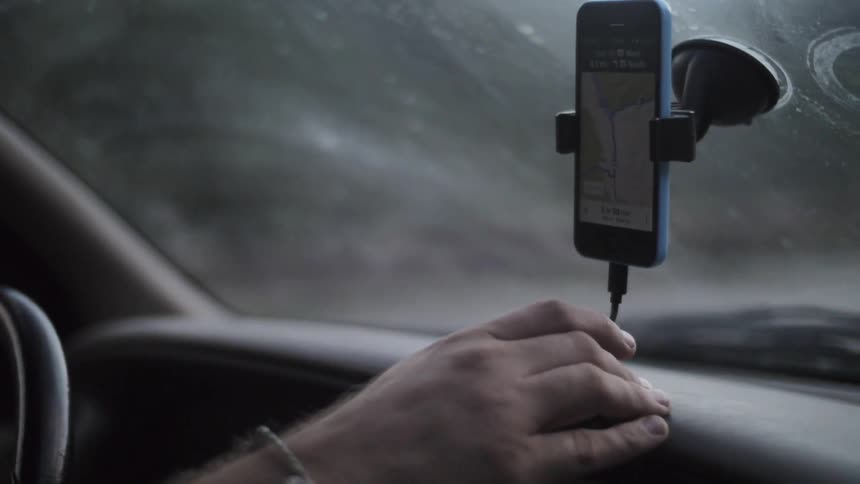 A man navigates with his phone while he drives
