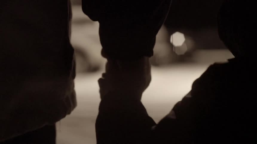 Close up of an adult and child holding hands