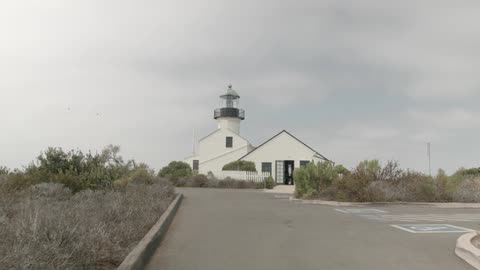 A lighthouse in the distance on a cloudy day