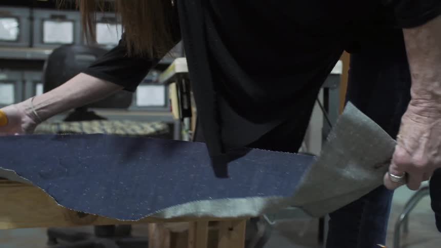 Woman cutting fabric with scissors