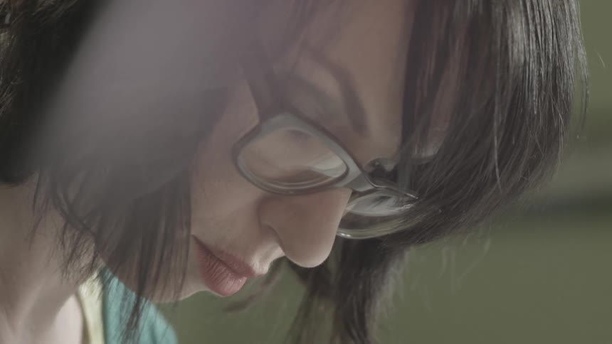 Woman concentrating on something inside of a room