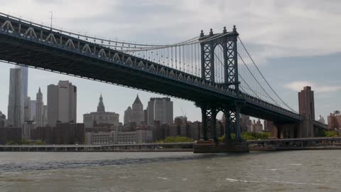Large bridge spanning over a river in a large city