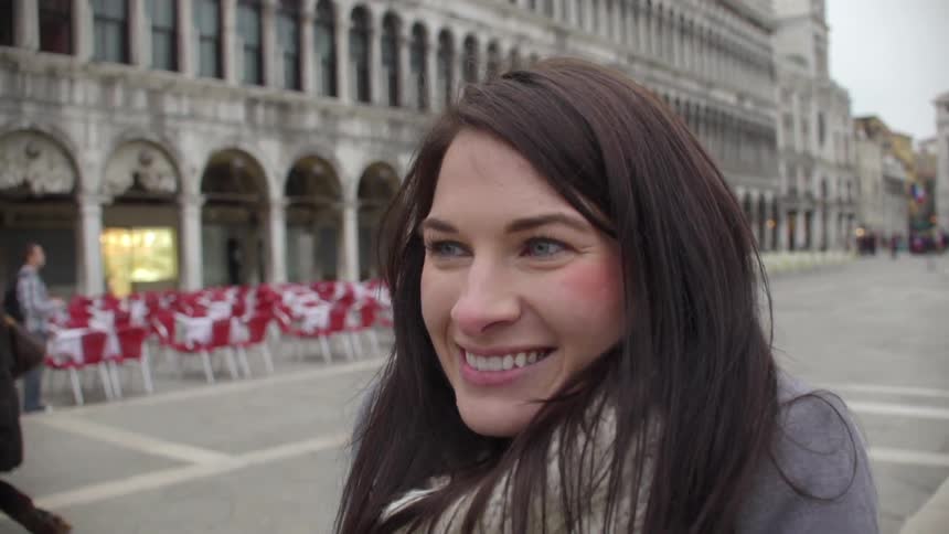 Woman smiling as her photo is taken on a cloudy day