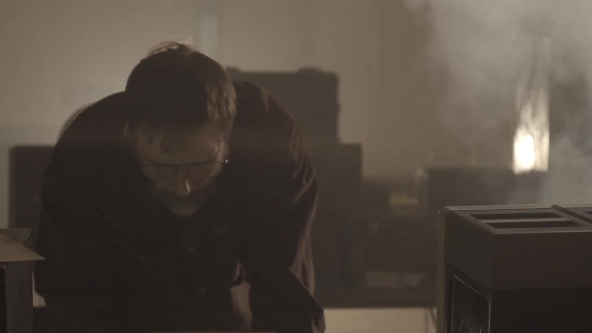 Man works in windy, smoky building