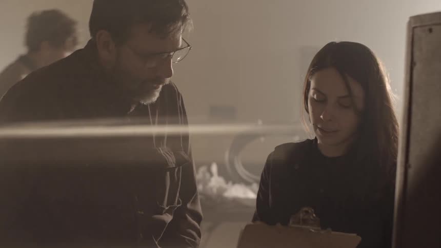 Man and Woman discuss plans on clipboard