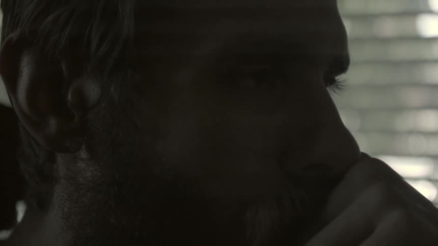 Closeup of a seated man deep in thought