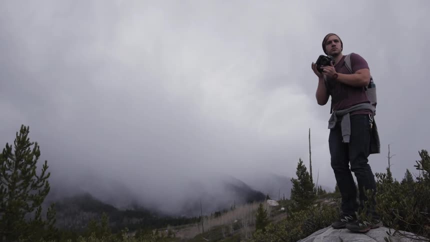 Man using a camera to take a photo on very cloudy day