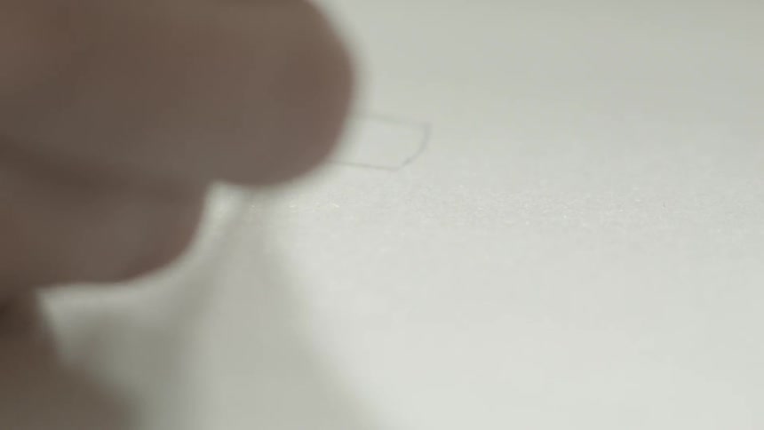 Person drawing on paper with a pencil