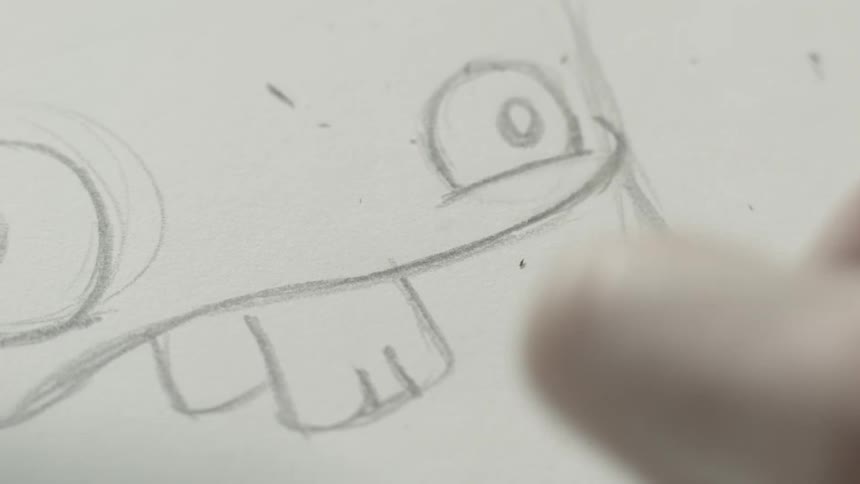 A person uses a pencil to sketch a funny face