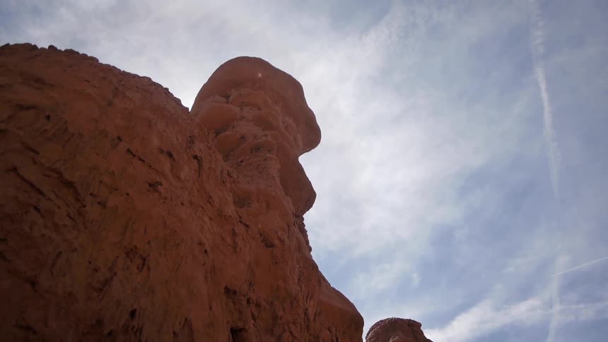 Red rock formation juts out against the sky