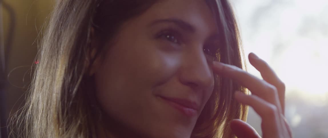 Woman smiles then looks up
