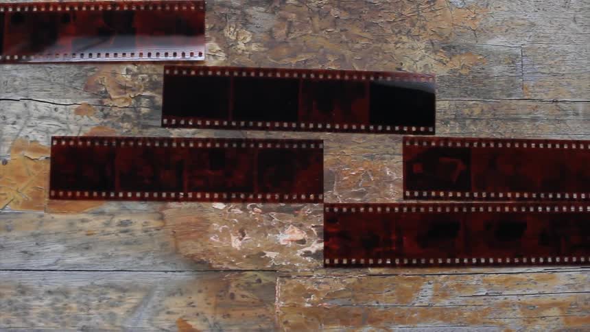 Photo negatives lined up on an old table