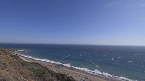 Waves crashing on a crowded beach