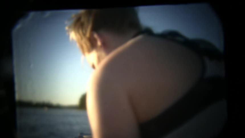 View of a young man and woman getting ready to go swimming off a boat