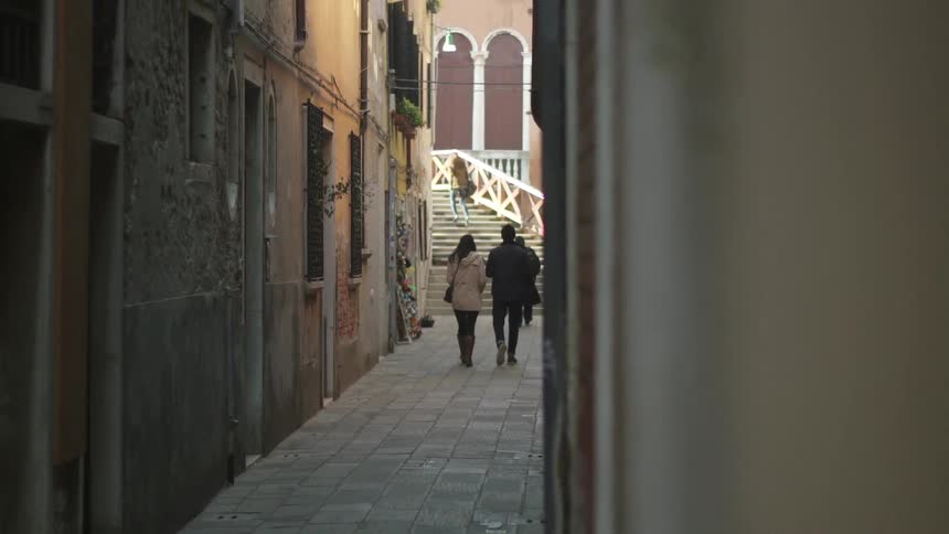 Pedestrians walk down an alley