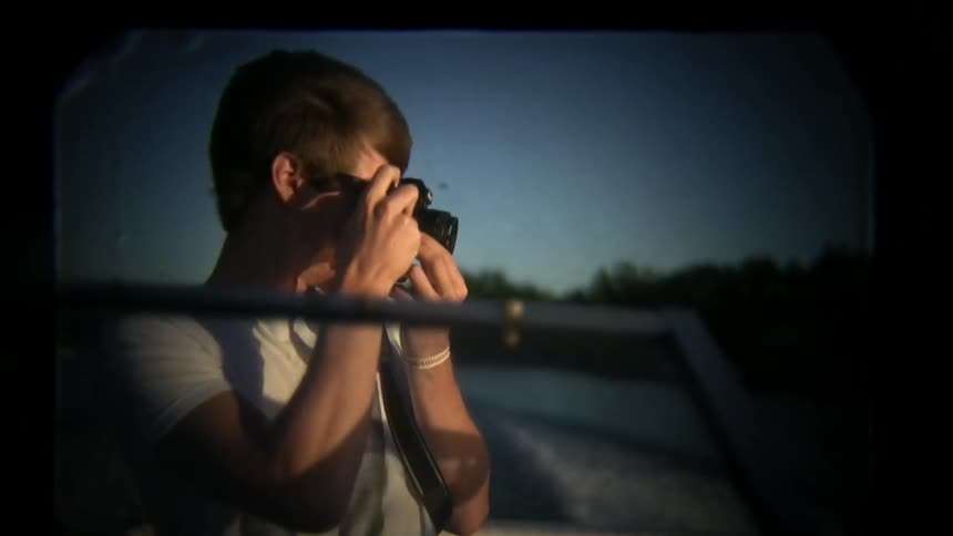 A person taking pictures on a boat