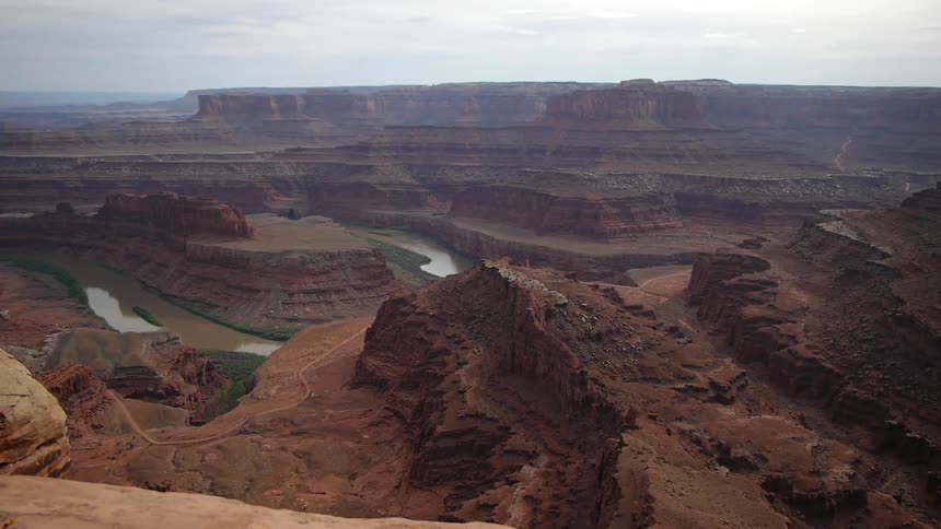 A canyon with a river with the sky in the background