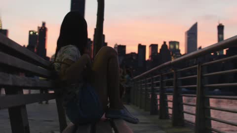 Woman watches morning city skyline