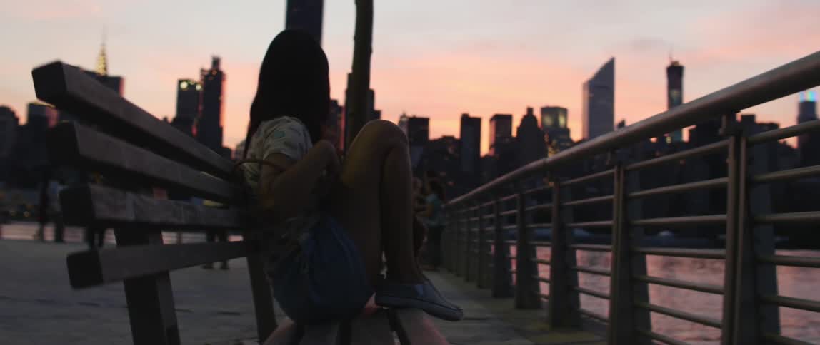 Woman watches morning city skyline