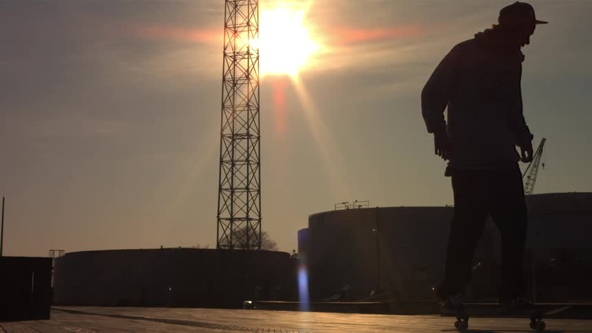 The sun shines down on a skateboarder