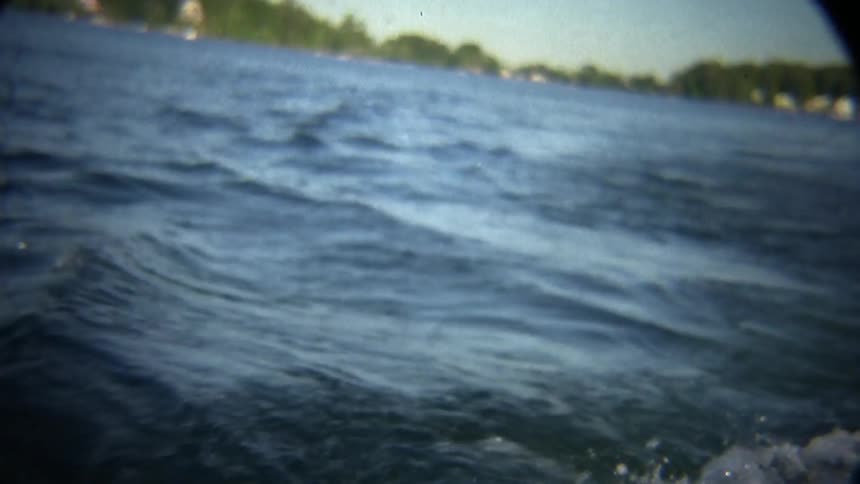 The water splashes as the boat moves in the lake