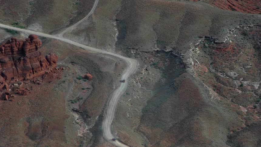 Vehicles traveling down twisting roads on mountains