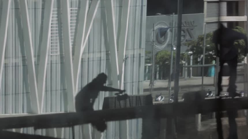 A man follows filming a person riding a skateboard