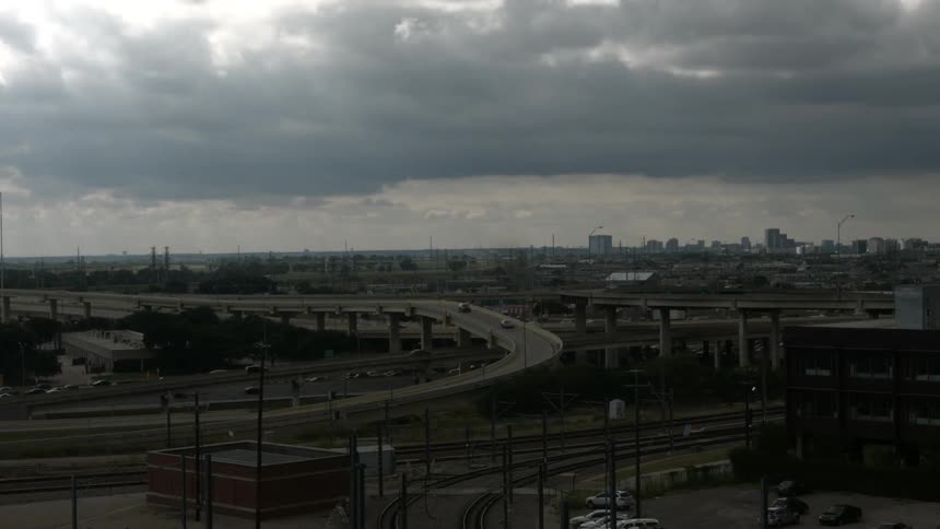 Fast forward of busy roads with large clouds overhead