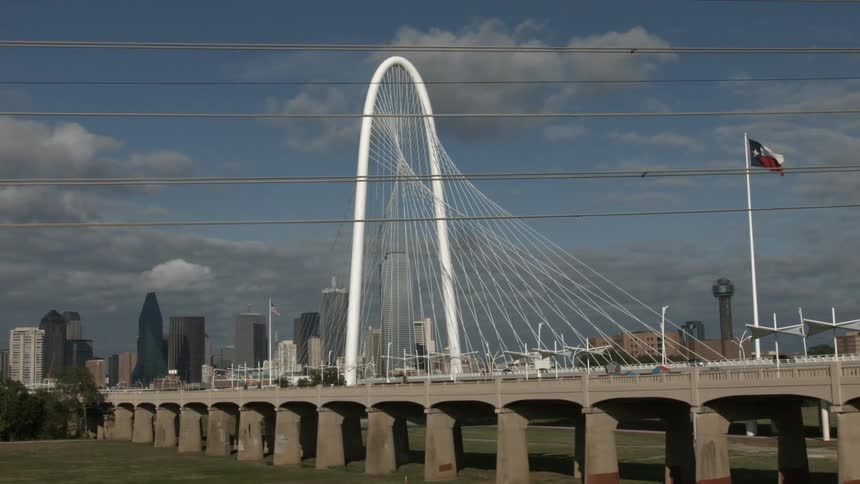 A time lapse of a city with a white arch
