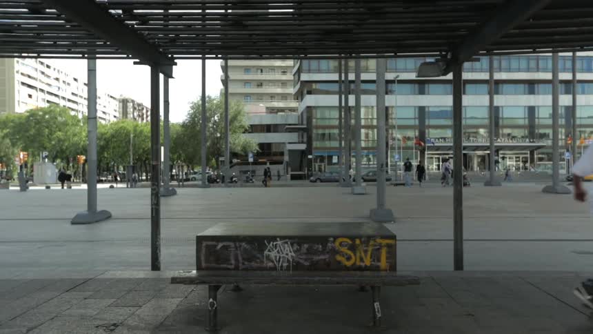 A man doing a skateboard trick off of a bench