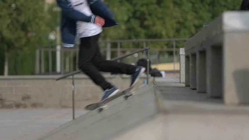 A skateboarder rides up and down a ramp