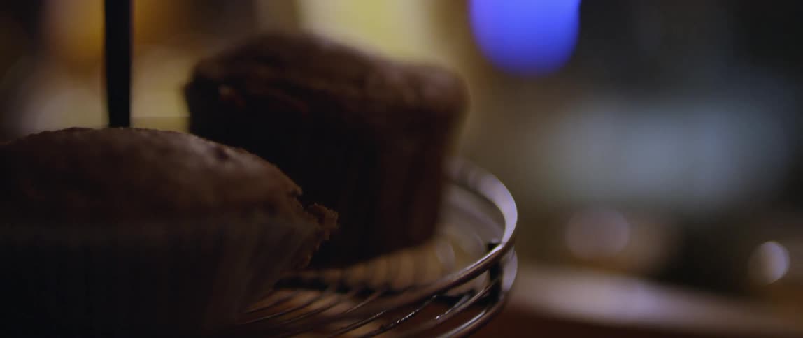 Baked goods sit on a round metal stand
