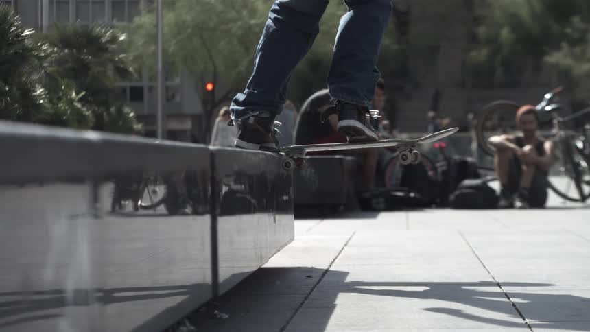 People watch as a person does a trick on a skateboard