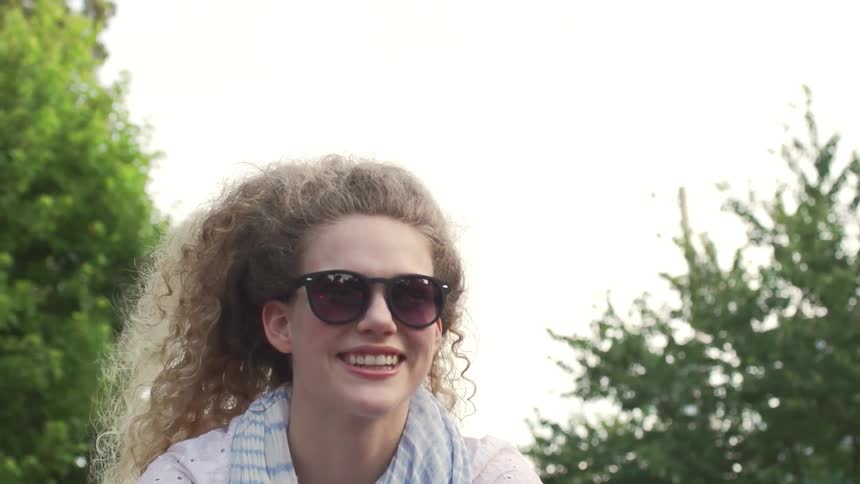 A woman smiles and laughs