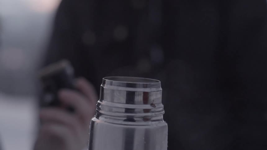 Steam escapes from a metal thermos