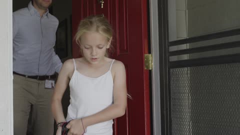 Door opens as a man follows a girl carrying a bag