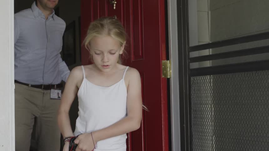 Door opens as a man follows a girl carrying a bag