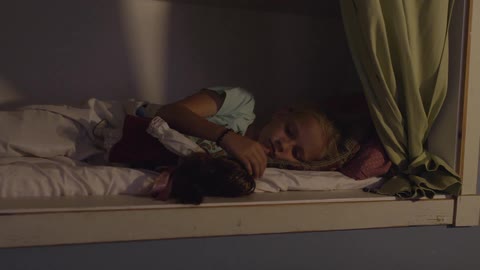 A girl laying down in bed