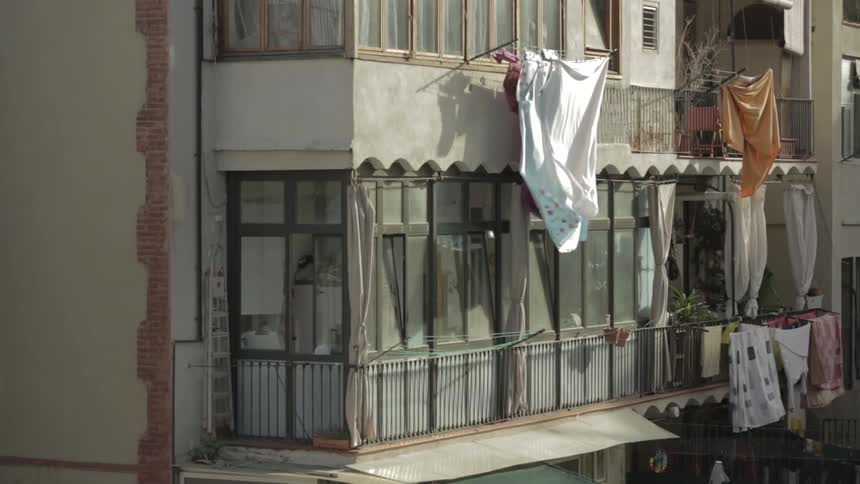 Laundry hangs out to dry on a city building