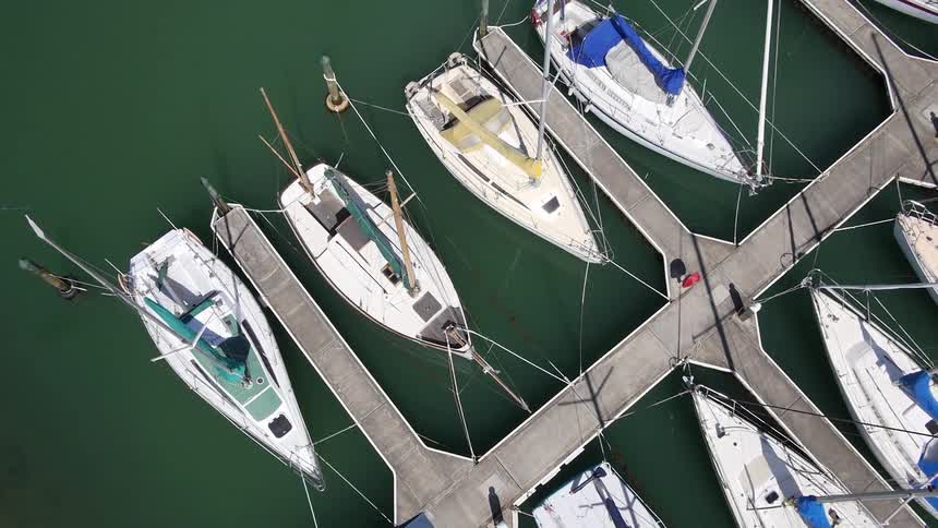 Small boats docked in dark green water