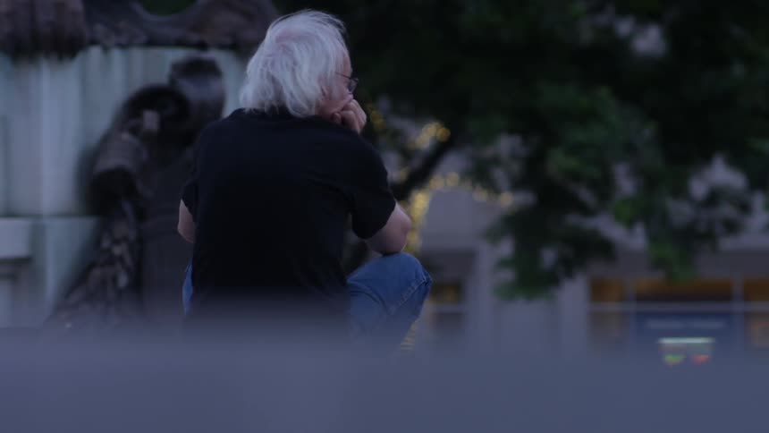 Man sitting down on a windy day