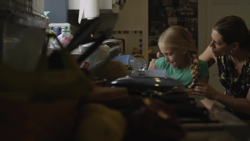 Girl throws a dish on the ground as her mom and they struggle